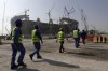 FILE - Workers walk to the Lusail Stadium, one of the 2022 World Cup stadiums, in Lusail, Qatar, Friday, Dec. 20, 2019. Paris has decided not to display the matches of the World Cup in Qatar on giant screens in fan zones amid concerns over rights violations of migrant workers and the environmental impact of the tournament that have led some other French cities to make the same decision. (AP Photo/Hassan Ammar, File)