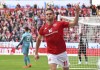 Marcus Ingvartsen from Mainz celebrates his side's opening goal during a German Bundesliga soccer match between FSV Mainz 05 and RB Leipzig in Mainz, Germany, Saturday, Oct.8, 2022. (Torsten Silz/dpa via AP)
