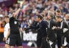 Fulham manager Marco Silva is shown a yellow card after arguing with referee Chris Kavanagh, left, after West Ham United is awarded their second goal scored by Gianluca Scamacca following a VAR check for handball during the English Premier League soccer match between Fulham and West Ham United at the London Stadium in London, Sunday Oct. 9, 2022. (Mike Egerton/PA via AP)