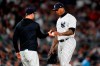 New York Yankees relief pitcher Aroldis Chapman hands the ball to manager Aaron Boone during the eighth inning of a baseball game against the Boston Red Sox Thursday, Sept. 22, 2022, in New York. (AP Photo/Frank Franklin II)