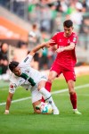 Cologne's Dejan Ljubicic, right, and Gladbach's Ramy Bensebaini battle for the ball during the Bundesliga soccer match between Borussia Monchengladbach and FC Cologne at Borussia-Park, Mönchengladbach, Germany, Sunday Oct. 9, 2022. (Marius Becker/dpa via AP)