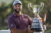 Jon Rahm, of Spain, holds the trophy after winning the Spanish Open golf tournament at Club de Campo Villa in Madrid, Spain, Sunday, Oct. 9, 2022. (AP Photo/Manu Fernandez)