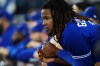Toronto Blue Jays first baseman Vladimir Guerrero Jr. (27) looks on from the dugout as they face the Seattle Mariners during ninth inning American League wild card MLB post-season baseball action in Toronto on Saturday, October 8, 2022. THE CANADIAN PRESS/Nathan Denette
