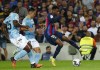 Barcelona's Ansu Fati, right, duels for the ball with Celta Vigo's Fran Beltran, center, and Celta Vigo's Joseph Aidoo during a Spanish La Liga soccer match between FC Barcelona and Celta Vigo at Camp Nou stadium in Barcelona, Spain, Sunday, Oct. 9, 2022. (AP Photo/Joan Monfort)