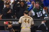 Baseball fans react as San Diego Padres starting pitcher Joe Musgrove (44) walks off the field at the end of the seventh inning of Game 3 of a National League wild-card baseball playoff series against the New York Mets, Sunday, Oct. 9, 2022, in New York. (AP Photo/Frank Franklin II)