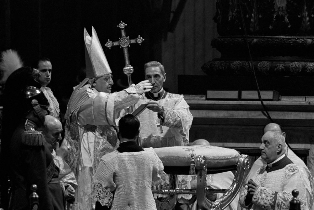 FILE - Pope John XXIII waves a hand in blessing at Roman Catholic Ecumenical Council at St. Peter's Basilica in Vatican City, Oct. 11, 1962. Pope Francis commemorates the 60th anniversary of the opening of the Second Vatican Council by celebrating a Mass in honor of St. John XXIII, the “good pope” who convened the landmark meetings that modernized the Catholic Church. (AP Photo/Raoul Fornezza, File)