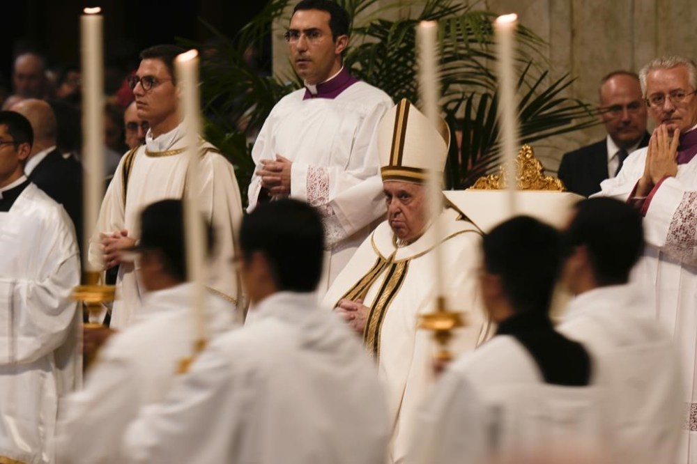 Pope Francis looks at the procession arriving for a mass in St. Peter's Basilica at the Vatican, Tuesday, Oct. 11, 2022. Pope Francis commemorates the 60th anniversary of the opening of the Second Vatican Council by celebrating a Mass in honor of St. John XXIII, the