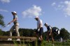 Cameron Smith, left, and Bryson DeChambeau, center, head to the 18th green during the first round of the LIV Golf Invitational-Chicago tournament Friday, Sept. 16, 2022, in Sugar Grove, Ill. (AP Photo/Charles Rex Arbogast)