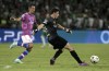 Maccabi's goalkeeper Josh Cohen kicks the ball as Juventus' Angel Di Maria tries to stop him during the group H Champions League soccer match between Maccabi Haifa and Juventus at Sammy Ofer stadium, in Haifa, Israel, Tuesday, Oct. 11, 2022. (AP Photo/Ariel Schalit)