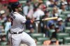 Atlanta Braves catcher Travis d'Arnaud (16) hits a solo homer during the second inning in Game 1 of a National League Division Series baseball game between the Atlanta Braves and the Philadelphia Phillies, Tuesday, Oct. 11, 2022, in Atlanta. (AP Photo/John Bazemore)