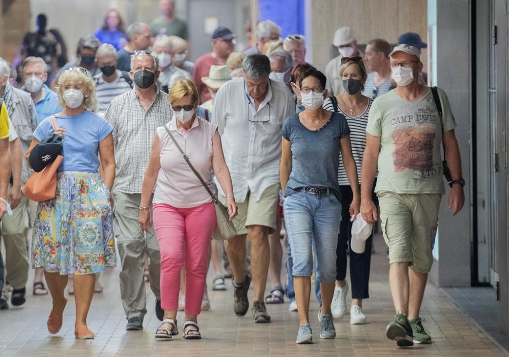 People wear face masks as they walk through a subway station in Montreal, Sunday, July 17, 2022, as the COVID-19 pandemic continues in the province. The number of hospitalizations linked to COVID-19 in Quebec has risen above 2,000 for the first time since mid-August. THE CANADIAN PRESS/Graham Hughes