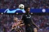 Brugge's Tajon Buchanan, top, jumps for a header with Atletico Madrid's Angel Correa during the group B Champions League soccer match between Atletico Madrid and Club Brugge at the Wanda Metropolitano stadium in Madrid, Spain, Wednesday, Oct. 12, 2022. (AP Photo/Manu Fernandez)
