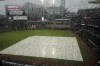 Rain hits a window overlooking Truist Park before Game 2 of baseball's National League Division Series between the Atlanta Braves and the Philadelphia Phillies, Wednesday, Oct. 12, 2022, in Atlanta. The game has been rain delayed. (AP Photo/John Bazemore)