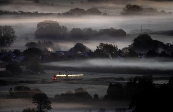 A regional train passes fog-covered fields in Wehrheim near Frankfurt, Germany. (Michael Probst / The Associated Press files)
