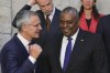 NATO Secretary General Jens Stoltenberg, left, speaks with U.S. Secretary for Defense Lloyd J. Austin III during a group photo of NATO defense ministers at NATO headquarters in Brussels, Thursday, Oct. 13, 2022. NATO Defense Ministers are convening in Brussels for the second day of talks to assess the situation in Ukraine, as the alliance committed on Wednesday to deliver more air defense supply to the country. (AP Photo/Olivier Matthys)
