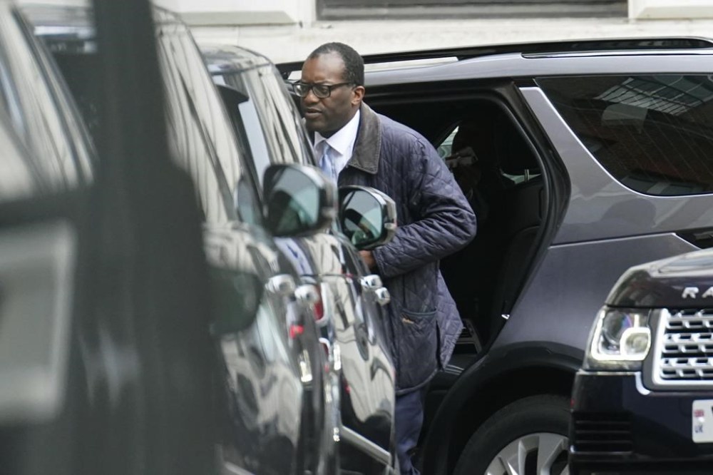 Britain's Chancellor of the Exchequer Kwasi Kwarteng arrives in Downing Street after returning from the US, in London, Friday, Oct. 14, 2022. The British government says Prime Minister Liz Truss will hold a news conference Friday as she faces pressure to U-turn on an economic package that sparked market turmoil. The announcement comes after Treasury chief Kwasi Kwarteng cut short a visit to Washington to fly back to London for crisis talks. (Stefan Rousseau/PA via AP)