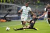 AC Milan's Matteo Gabbia tries to tackle Chelsea's Reece James, left, during the Champions League group E soccer match between AC Milan and Chelsea at the San Siro stadium in Milan, Italy, Tuesday, Oct. 11, 2022. (AP Photo/Antonio Calanni)