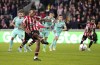 Brentford's Ivan Toney scores against Brighton and Hove Albion during the English Premier League soccer match at the Gtech Community Stadium, London, Friday Oct. 14, 2022. (John Walton/PA via AP)