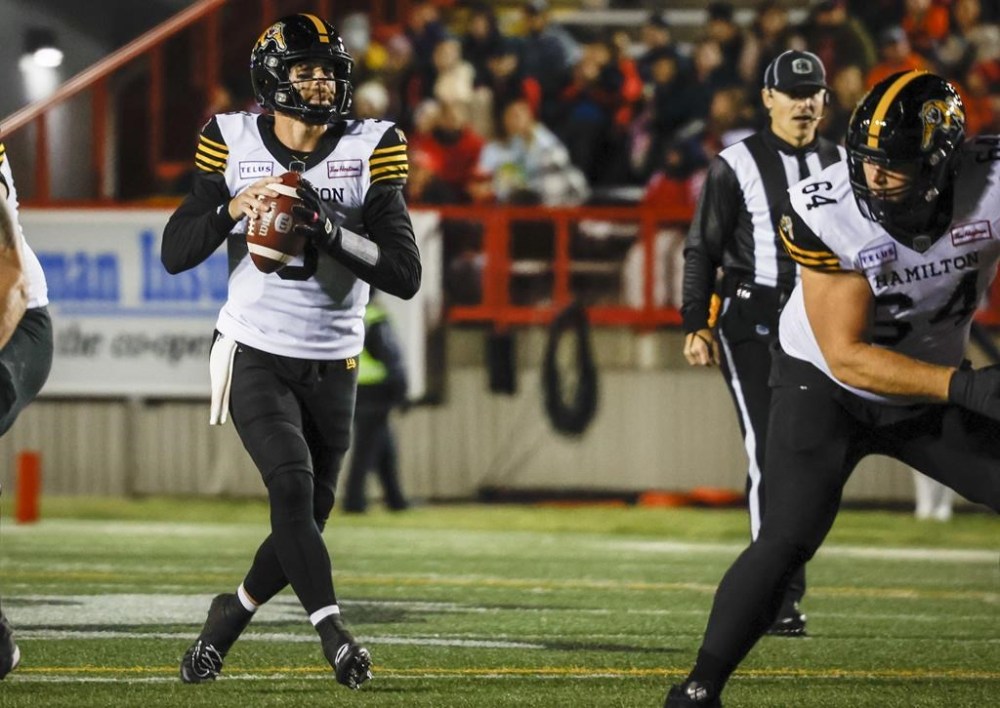 Hamilton Tiger-Cats quarterback Dane Evans looks for a receiver during first half CFL football action against the Calgary Stampeders in Calgary, Friday, Oct. 14, 2022.THE CANADIAN PRESS/Jeff McIntosh