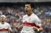 Stuttgart's Wataru Endo celebrates after scoring to 4-1 during a German Bundesliga soccer match between VfB Stuttgart and VfL Bochum in Stuttgart, Germany, Saturday, Oct.15, 2022. (Marijan Murat/dpa via AP)