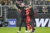 Bayern's Alphonso Davies, center, leaves the field after getting injured during the German Bundesliga soccer match between Borussia Dortmund and Bayern Munich in Dortmund, Germany, Saturday, Oct. 8, 2022.&nbsp;Bayern Munich manager Julian Nagelsmann says Canadian star Davies, who suffered a cranial bruise after taking a boot to the head last weekend, could figure in Sunday's game against SC Freiburg. THE CANADIAN PRESS/AP-Martin Meissner