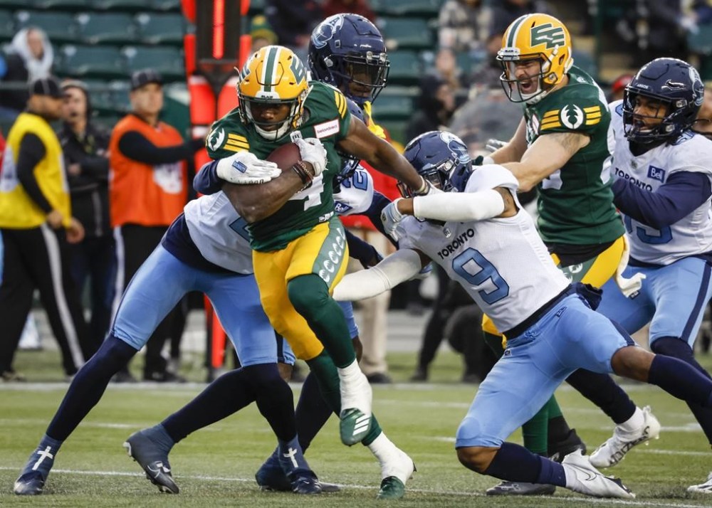 Toronto Argonauts' Royce Metchie, right, lets Edmonton Elks' Kevin Brown escape his grasp during first half CFL football action in Edmonton, Saturday, Oct. 15, 2022.THE CANADIAN PRESS/Jeff McIntosh