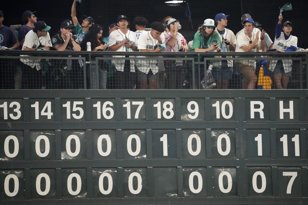 Seattle Mariners fans react after the Houston Astros scored during the 18th inning in Game 3 of an American League Division Series baseball game Saturday, Oct. 15, 2022, in Seattle. (AP Photo/Ted S. Warren)