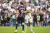 Barcelona's Robert Lewandowski and Real Madrid's Toni Kroos, right, embrace each other at the end of a Spanish La Liga soccer match between Real Madrid and Barcelona at the Santiago Bernabeu stadium in Madrid, Sunday, Oct. 16, 2022. Real Madrid won 3-1. (AP Photo/Manu Fernandez)