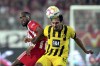 Union's Jordan Siebatcheu, left, and Dortmund's Mats Hummels, right, challenge for the ball during the German Bundesliga soccer match between 1. FC Union Berlin and Borussia Dortmund in Berlin, Germany, Sunday, Oct. 16, 2022. (AP Photo/Michael Sohn)