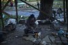 A man cooks on a makeshift stove in Kivsharivka, Ukraine, Sunday, Oct. 16, 2022. Residents in Kivsharivka have been living with no gas, electricity or running water supply for around three weeks. (AP Photo/Francisco Seco)