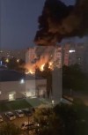 In this handout photo taken from video released by Ostorozhno Novosty, flames and smoke engulf a building after a warplane crashed into a residential area in Yeysk, Russia, Monday, Oct. 17, 2022. The Russian military says one of its warplanes crashed in the port of Yeysk on the Sea of Azov after experiencing engine failure. The Russian Defense Ministry said that a Su-34 bomber crashed into a residential area in Yeysk and caused a fire on Monday. (Ostorozhno Novosty via AP)