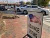 A sign showing the way for voters stands outside a Cobb County voting building during the first day of early voting, Monday, Oct. 17, 2022, in Marietta, Ga. (AP Photo/Mike Stewart)