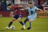 FC Dallas forward Alan Velasco (20) and Minnesota United midfielder Will Trapp (20) vie for control of the ball during the first half of an MLS soccer playoff match in Frisco, Texas, Monday, Oct. 17, 2022. (AP Photo/LM Otero)