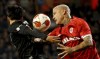 FILE - Frankfurt's Daichi Kamada, left, goes up against Royal Antwerp's Radja Nainggolan during the Europa League group D soccer match between Royal Antwerp and Frankfurt at the Bosuil Stadium in Deurne, Belgium, Sept. 30, 2021. Former Belgium international Radja Nainggolan was suspended until further notice on Monday, Oct. 17, 2022, by Royal Antwerp after he was caught smoking an electronic cigarette on the substitutes' bench. The Belgian club also mentioned Nainggolan’s performances, and how his behavior can affect the squad, to justify the decision. (AP Photo/Olivier Matthys, File)