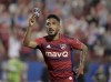 FC Dallas forward Jesus Ferreira (10) celebrates a goal against the Seattle Sounders while holding photos of his family on his shin guard in the second half of an MLS soccer match Saturday, May 7, 2022, in Frisco, Texas. THE CANADIAN PRESS/AP-The Dallas Morning News-Matt Strasen