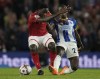 Nottingham Forest's Orel Mangala, left, challenges for the ball with Brighton's Moises Caicedo during the English Premier League soccer match between Brighton and Nottingham Forest at the Falmer stadium in Brighton, England, Tuesday, Oct. 18, 2022. (AP Photo/Alastair Grant)