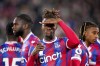Crystal Palace's Wilfried Zaha, centre, gestures. ahead of the English Premier League soccer match between Crystal Palace and Wolverhampton Wanderers at Selhurst Park, London, Tuesday, Oct. 18, 2022. (Zac Goodwin/PA via AP)