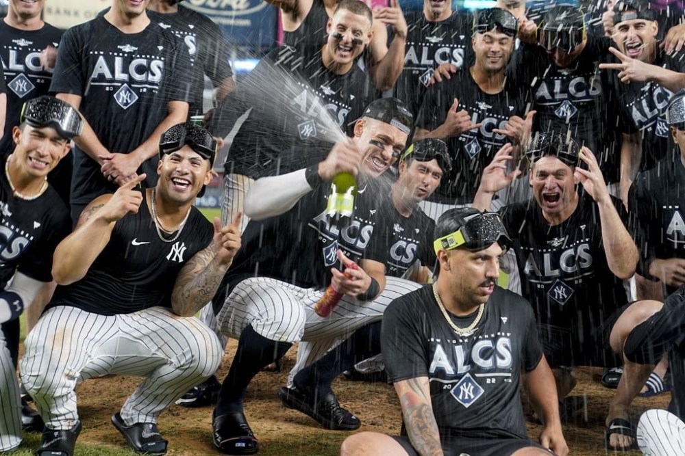New York Yankees Aaron Judge sprays champagne while celebrating with teammates after the Yankees defeated the Cleveland Guardians in Game 5 of an American League Division baseball series, Tuesday, Oct. 18, 2022, in New York. (AP Photo/John Minchillo)