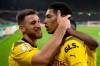 Dortmund's Jude Bellingham, centre, celebrates after his penalty goal to 0-2 during the German soccer cup second round match between Hannover 96 and Borussia Dortmund, at Heinz von Heiden Arena in Hannover, Germany, Wednesday October 19, 2022. (Swen Pfortner/dpa via AP)