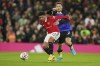 Tottenham's Matt Doherty, right, and Manchester United's Jadon Sancho battle for the ball during the English Premier League soccer match between Manchester United and Tottenham Hotspur at Old Trafford in Manchester, England, Wednesday, Oct. 19, 2022. (AP Photo/Dave Thompson)