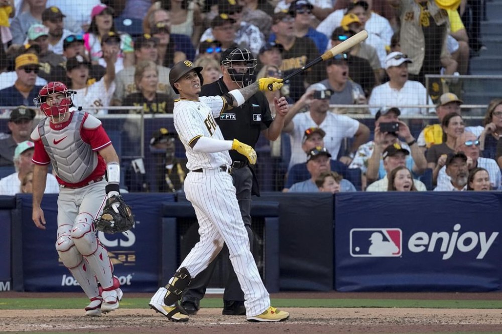 San Diego Padres' Manny Machado watches his home run during the seventh inning in Game 2 of the baseball NL Championship Series between the San Diego Padres and the Philadelphia Phillies on Wednesday, Oct. 19, 2022, in San Diego. (AP Photo/Ashley Landis)