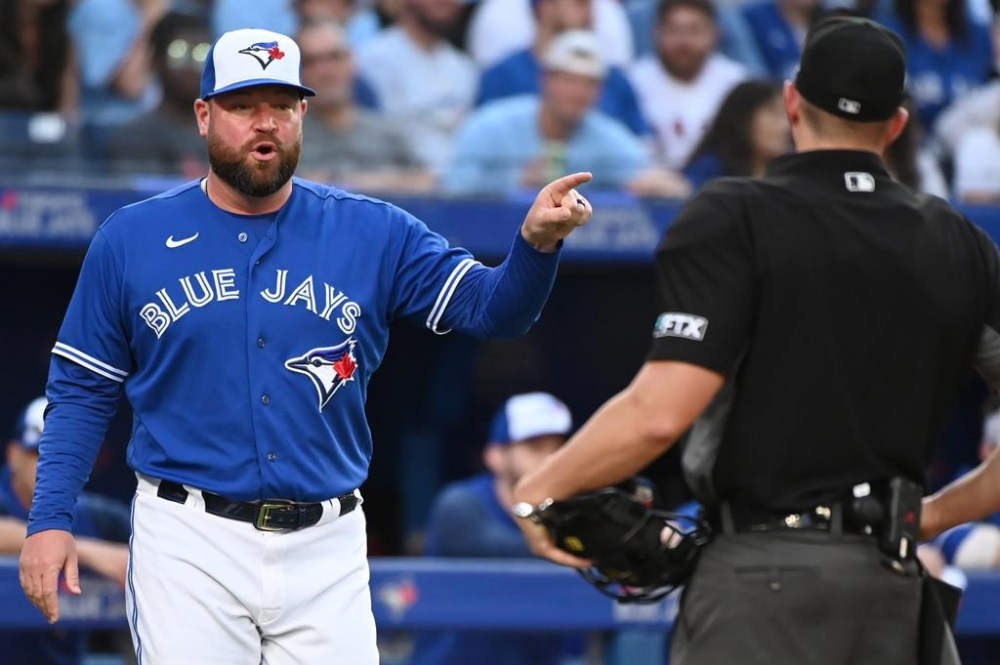 Toronto Blue Jays interim manager John Schneider, left, argues with home plate umpire Shane Livensparger after being ejected from the game during eighth inning American League baseball action against the Los Angeles Angels in Toronto on Saturday, Aug. 27, 2022. Schneider will return as manager of the Toronto Blue Jays next season. The team says the two sides have agreed to terms on a three-year contract with a team option for the 2026 season. THE CANADIAN PRESS/Jon Blacker