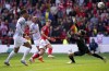 Liverpool goalkeeper Alisson Becker saves a shot from Nottingham Forest's Ryan Yates, center, during the English Premier League soccer match between Nottingham Forest and Liverpool, at the City Ground, in Nottingham, England, Saturday, Oct. 22, 2022. (Joe Giddens/PA via AP)