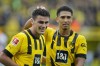 Dortmund's Giovanni Reyna, left, celebrates after scoring his side's third goal during the German Bundesliga soccer match between Borussia Dortmund and VfB Stuttgart in Dortmund, Germany, Saturday, Oct. 22, 2022. (AP Photo/Martin Meissner)