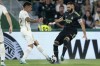 Elche's Nicolas Fernandez Mercau, left, challenges Real Madrid's Karim Benzema during the Spanish La Liga soccer match between Elche and Real Madrid at the Martinez Valero Stadium in Elche, Spain, Wednesday, Oct. 19, 2022. (AP Photo/Alberto Saiz)