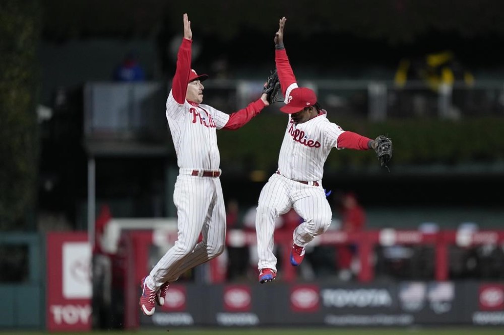 Philadelphia Phillies' Jean Segura and Bryson Stott celebrate their win in Game 4 of the baseball NL Championship Series between the San Diego Padres and the Philadelphia Phillies on Saturday, Oct. 22, 2022, in Philadelphia. (AP Photo/Matt Slocum)