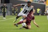 Udinese's Destiny Udogie, left, and Torino's Sasa Lukic battle for the ball during the Serie A soccer match between Udinese and Torino at Friuli Stadium, Udine, Italy, Sunday Oct. 23, 2022. (Andrea Bressanutti/LaPresse via AP)