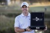 Rory McIlroy, of Northern Ireland, holds the winning trophy after the final round of the CJ Cup golf tournament Sunday, Oct. 23, 2022, in Ridgeland, S.C. (AP Photo/Stephen B. Morton)