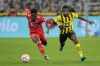 Bayern's Alphonso Davies vies for the ball with Dortmund's Youssoufa Moukoko, right, during the German Bundesliga soccer match between Borussia Dortmund and Bayern Munich in Dortmund, Germany, Saturday, Oct. 8, 2022. THE CANADIAN PRESS/AP/Martin Meissner