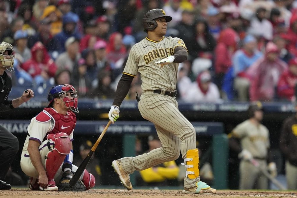 San Diego Padres' Juan Soto watches his home run during the fourth inning in Game 5 of the baseball NL Championship Series between the San Diego Padres and the Philadelphia Phillies on Sunday, Oct. 23, 2022, in Philadelphia. (AP Photo/Matt Slocum)